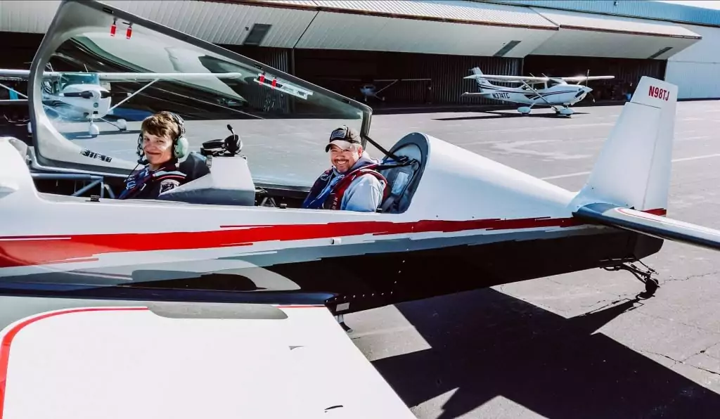Rob Holland in an aircraft, with a student