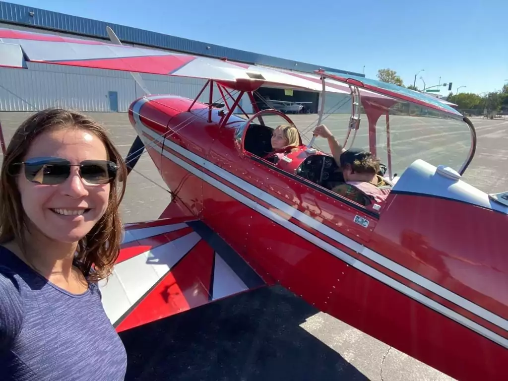 A young student with a trainer in a red plane